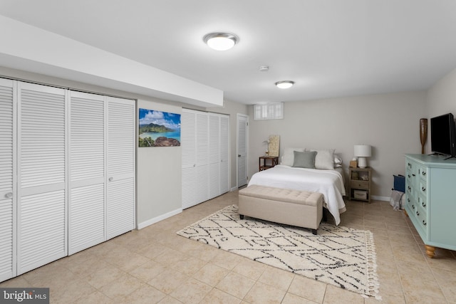 bedroom featuring baseboards and light tile patterned floors