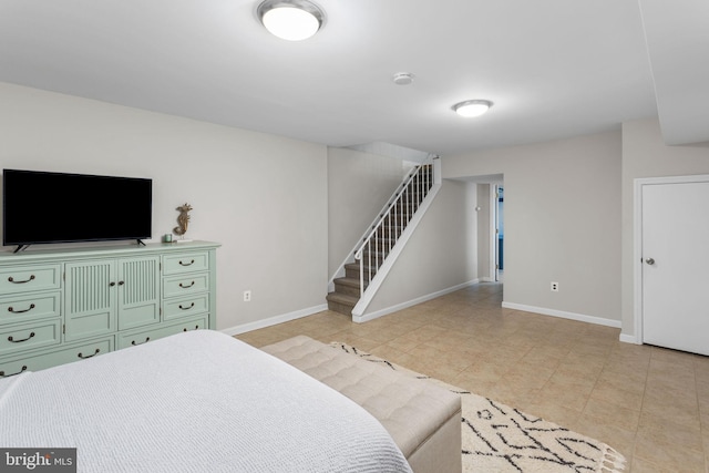 bedroom with baseboards and light tile patterned flooring