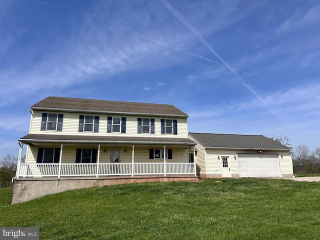 view of front of house with covered porch, a front yard, and an attached garage