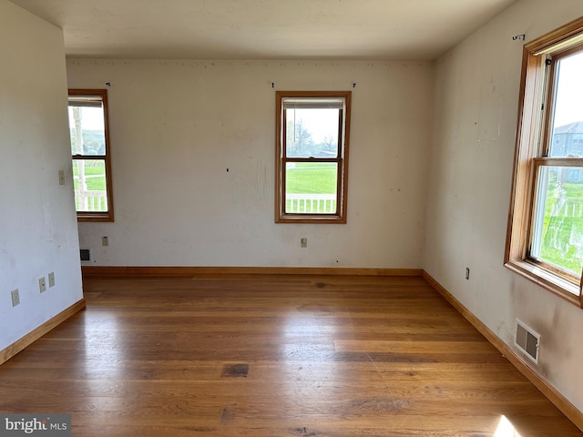 empty room with light wood-type flooring and baseboards