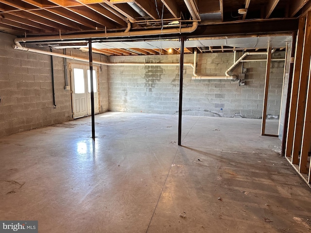below grade area featuring concrete block wall