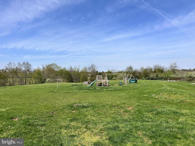 view of grassy yard with a playground