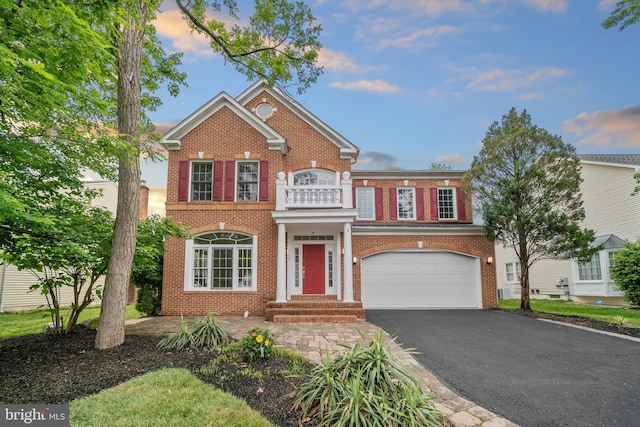 2054 Madrillon Rd, Vienna, VA 22182 - colonial house with brick siding, an attached garage, a balcony, and driveway