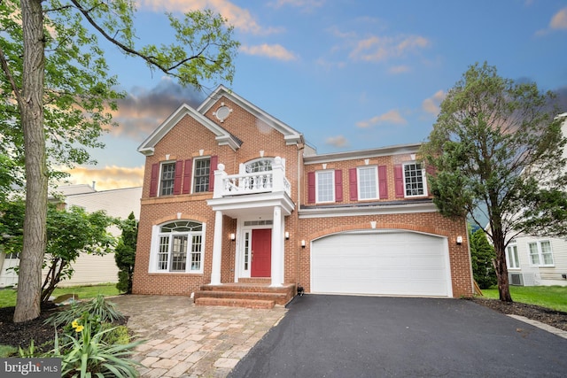 2054 Madrillon Rd, Vienna, VA 22182 - colonial home featuring a balcony, driveway, a garage, and brick siding