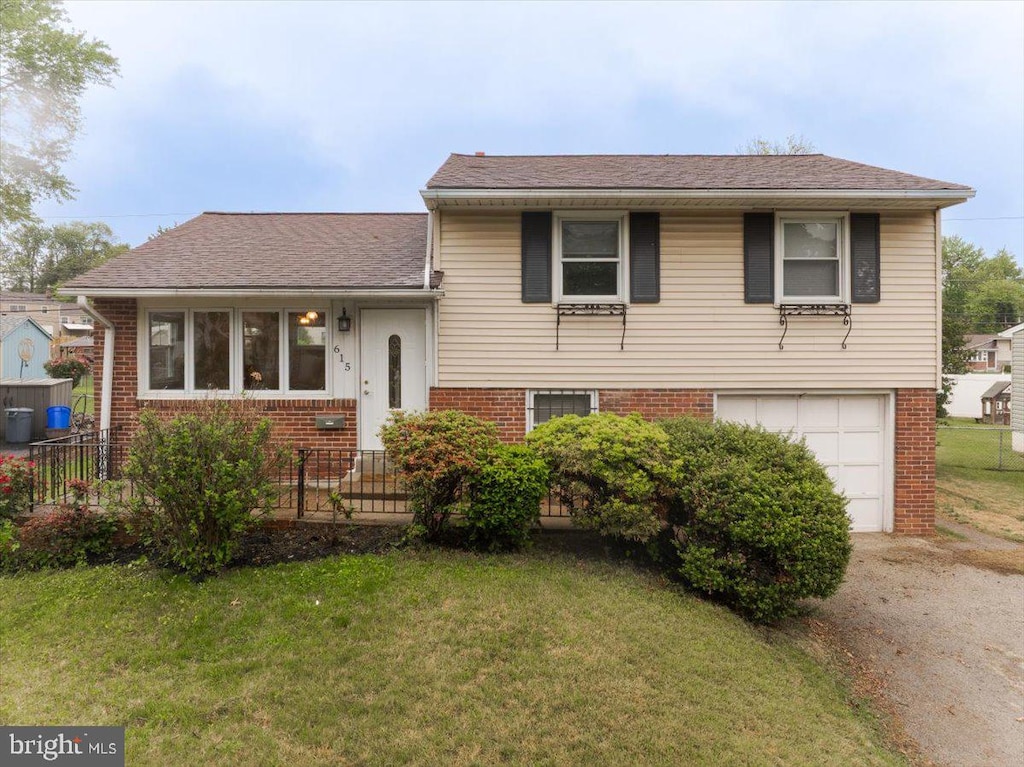 615 Wynnbrook Rd, Secane, PA 19018 - split level home with brick siding, a garage, driveway, and roof with shingles