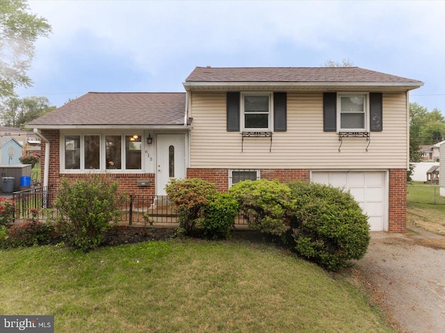 615 Wynnbrook Rd, Secane, PA 19018 - split level home with brick siding, a garage, driveway, and roof with shingles