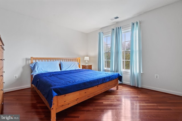 bedroom featuring wood-type flooring and baseboards
