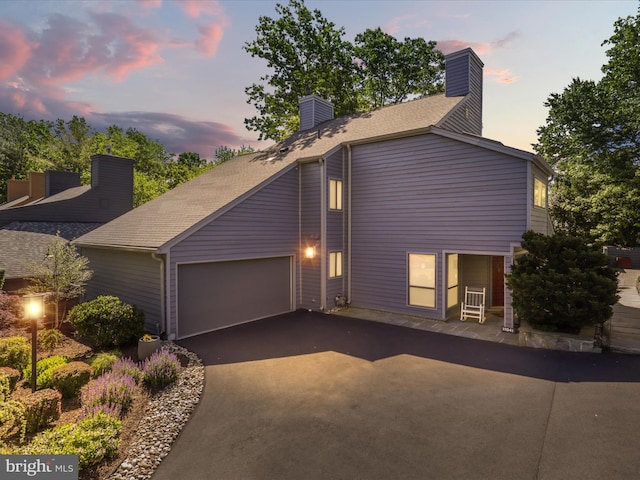 11041 Solaridge Dr, Reston, VA 20191 - view of front of home featuring asphalt driveway, an attached garage, a chimney, and roof with shingles