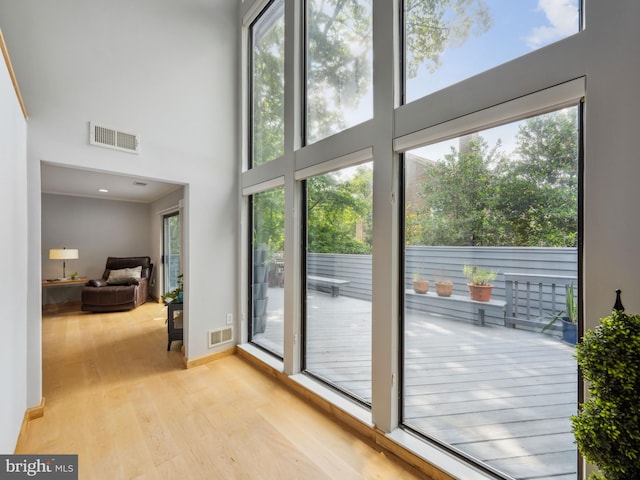 11041 Solaridge Dr, Reston, VA 20191 - doorway to outside featuring a high ceiling, wood finished floors, and baseboards
