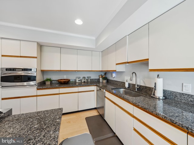 11041 Solaridge Dr, Reston, VA 20191 - kitchen featuring stainless steel appliances, a sink, ornamental molding, white cabinetry, and light wood-type flooring