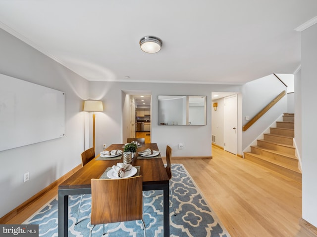 11041 Solaridge Dr, Reston, VA 20191 - dining space with wood finished floors, baseboards, crown molding, and stairs