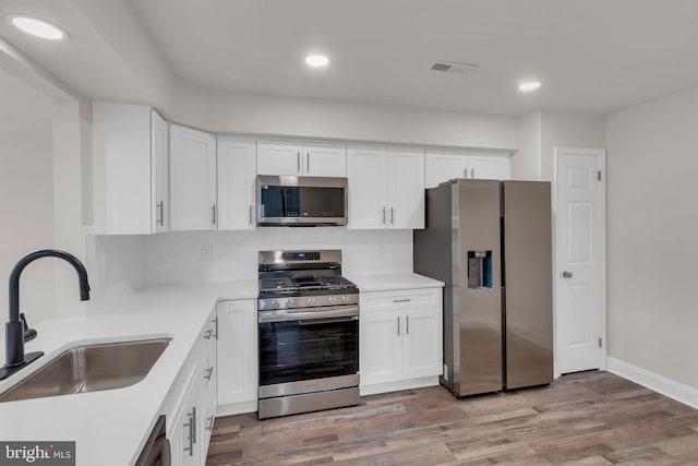 66 Cypress Pl, Newtown, PA 18940 - kitchen with stainless steel appliances, a sink, white cabinetry, and recessed lighting