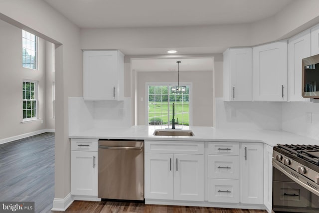 66 Cypress Pl, Newtown, PA 18940 - kitchen with stainless steel appliances, a sink, white cabinets, light countertops, and recessed lighting