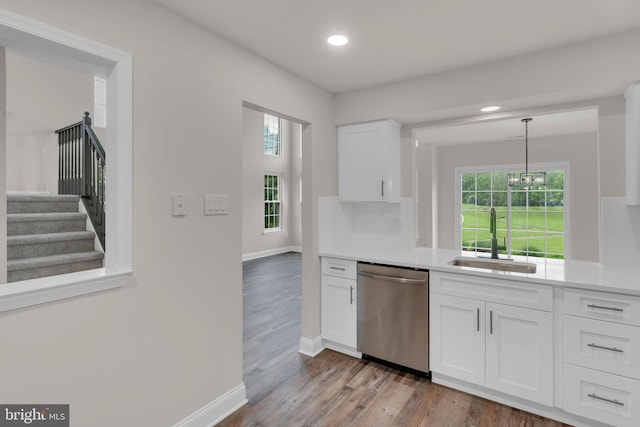 66 Cypress Pl, Newtown, PA 18940 - kitchen featuring dishwasher, a sink, white cabinets, wood finished floors, and light countertops