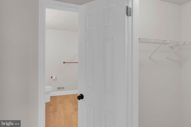 66 Cypress Pl, Newtown, PA 18940 - bathroom with baseboards, toilet, wood finished floors, and a spacious closet