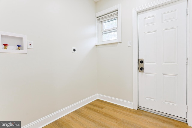 laundry room featuring washer hookup, hookup for an electric dryer, light wood-style floors, and baseboards