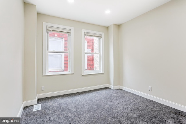 empty room with carpet floors, baseboards, and recessed lighting