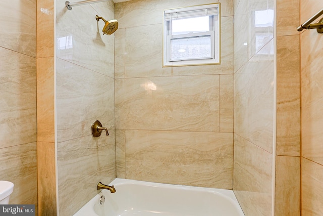 bathroom featuring toilet and washtub / shower combination
