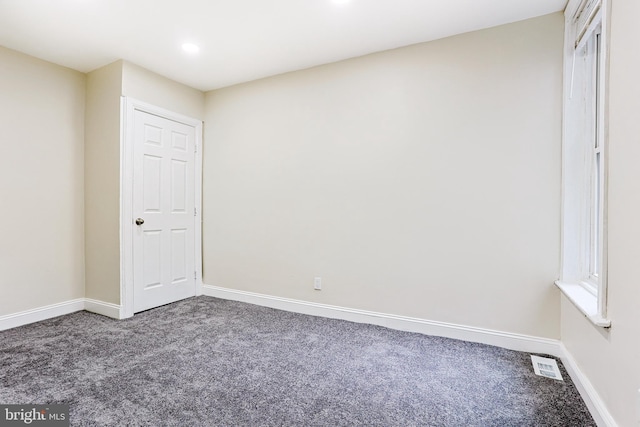 spare room with carpet floors, baseboards, and recessed lighting