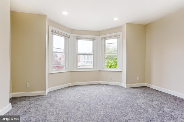 carpeted empty room featuring baseboards and recessed lighting