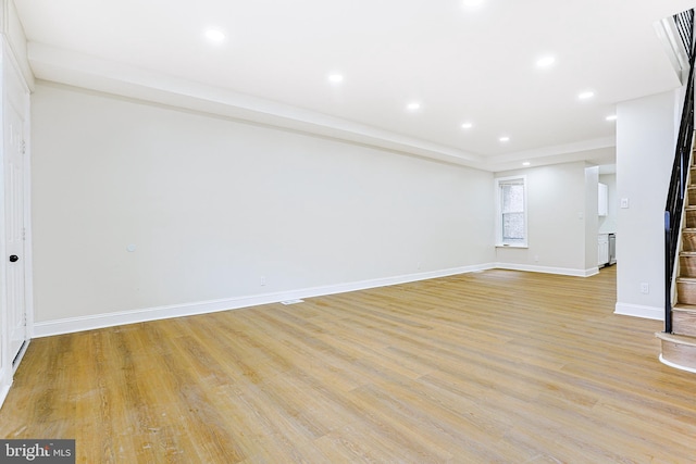 unfurnished living room featuring light wood-type flooring, baseboards, and recessed lighting
