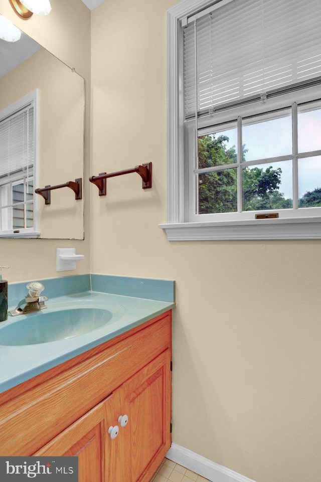 bathroom featuring baseboards, vanity, and tile patterned floors