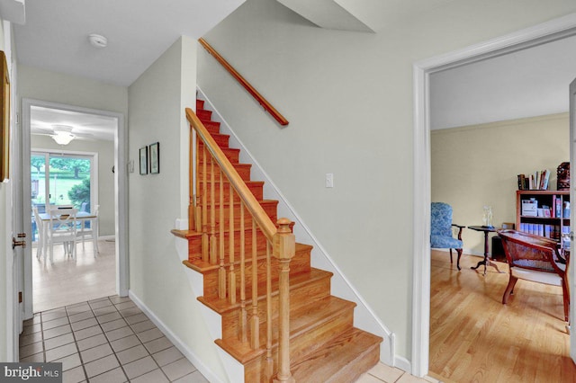 staircase with tile patterned floors and baseboards