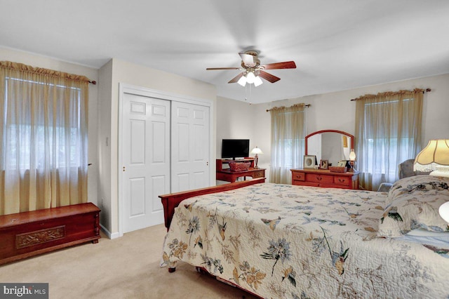 carpeted bedroom with a closet and a ceiling fan