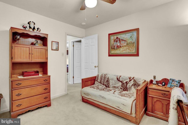 sitting room featuring a ceiling fan, light carpet, and baseboards