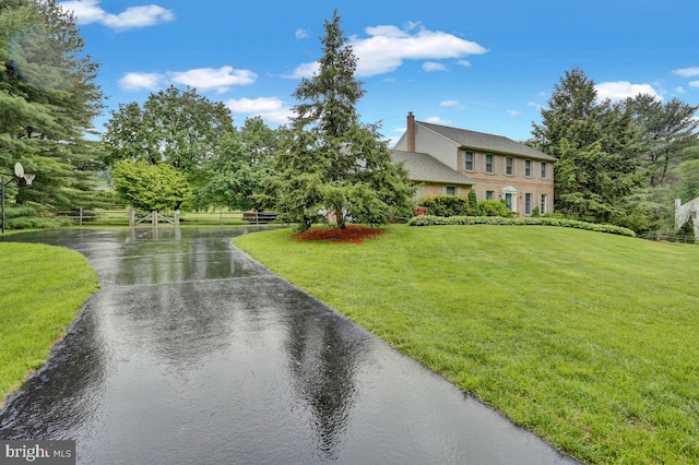 view of front of property with a front yard and a water view