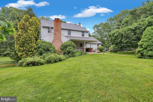 back of property with a chimney, an attached garage, and a porch