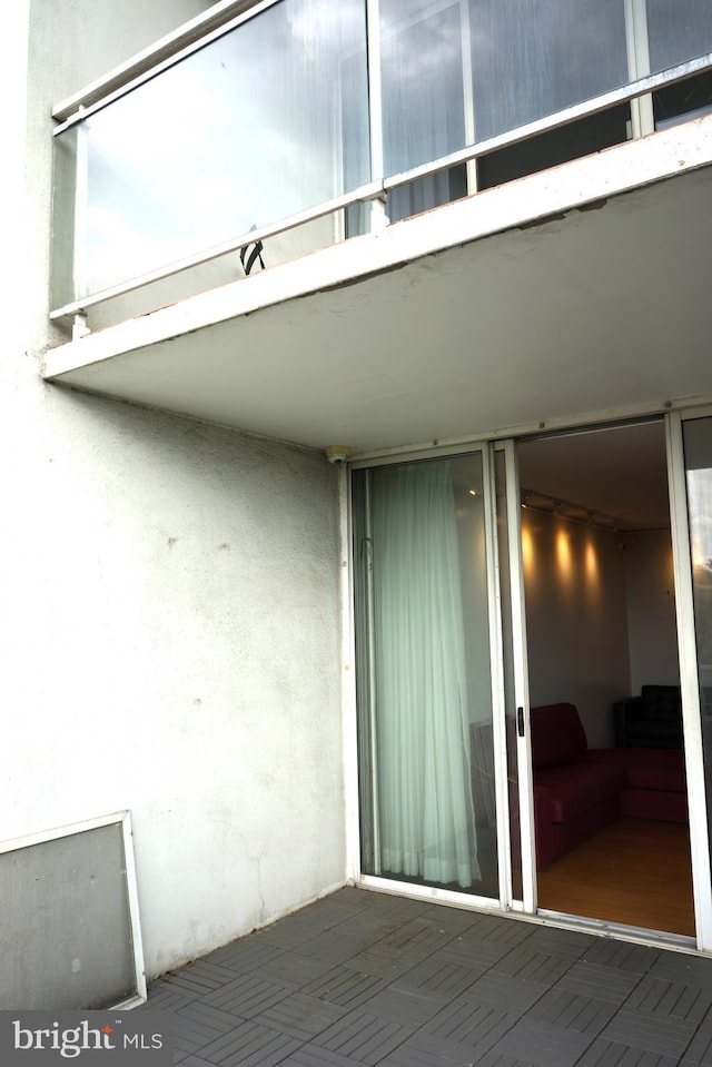 view of exterior entry featuring stucco siding