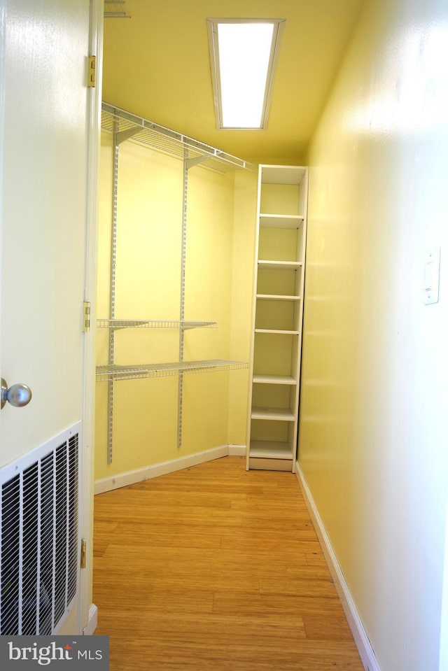 spacious closet featuring wood finished floors