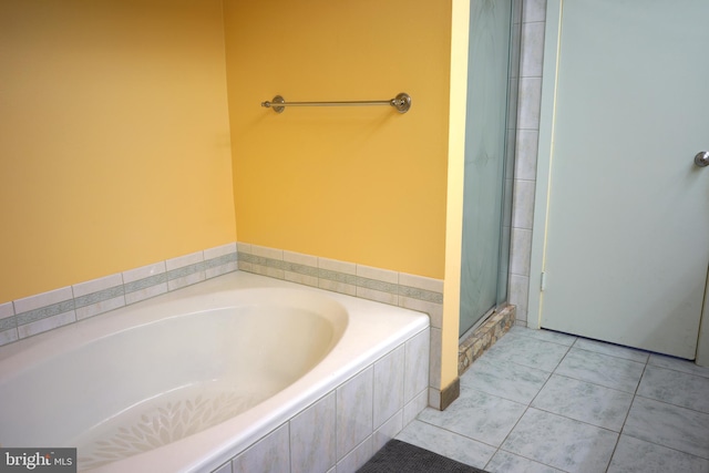 bathroom featuring a garden tub, tile patterned flooring, and an enclosed shower