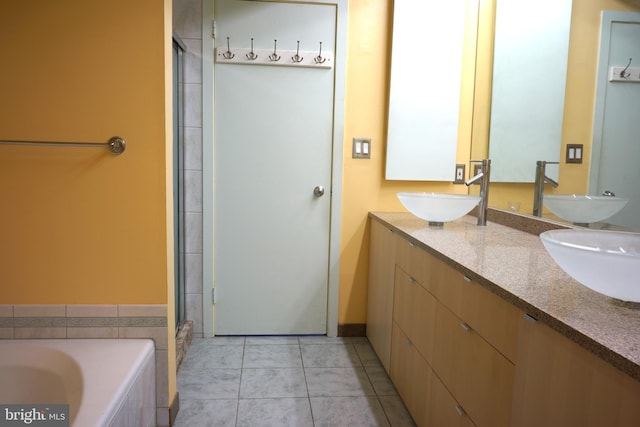 full bath with double vanity, a bath, a shower with door, and tile patterned floors