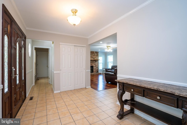 55 Cambridge Way, Princeton Junction, NJ 08550 - entrance foyer featuring a fireplace, light tile patterned flooring, crown molding, ceiling fan, and baseboards