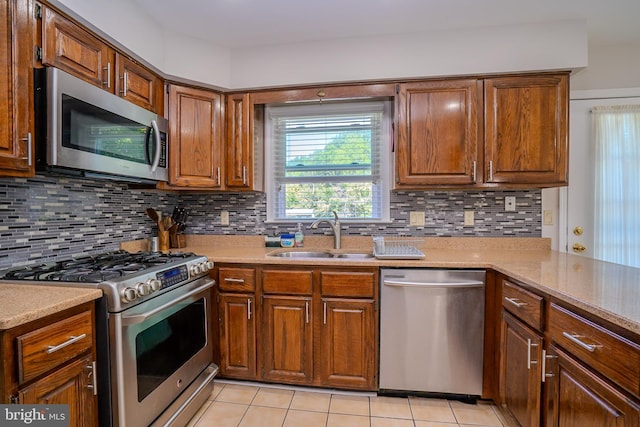 55 Cambridge Way, Princeton Junction, NJ 08550 - kitchen with stainless steel appliances, a sink, light tile patterned flooring, and brown cabinets