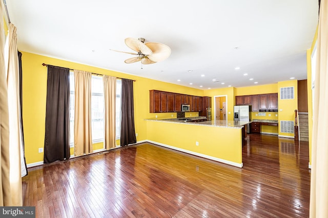 15602 Sir Edwards Dr, Upper Marlboro, MD 20772 - kitchen with dark wood-style floors, a peninsula, stainless steel microwave, a ceiling fan, and baseboards