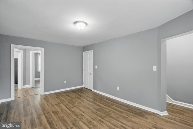 unfurnished bedroom with baseboards and wood finished floors