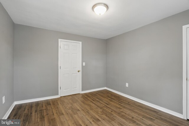 empty room featuring baseboards and wood finished floors