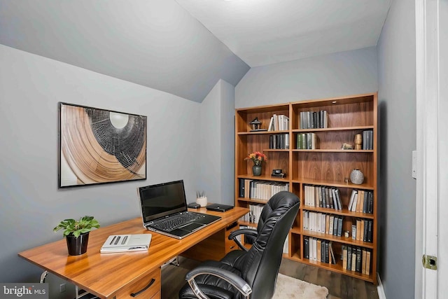 home office with lofted ceiling and wood finished floors