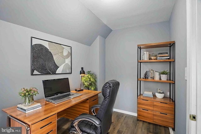 office area featuring dark wood-style flooring, vaulted ceiling, and baseboards