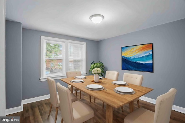 dining space featuring baseboards and dark wood-type flooring