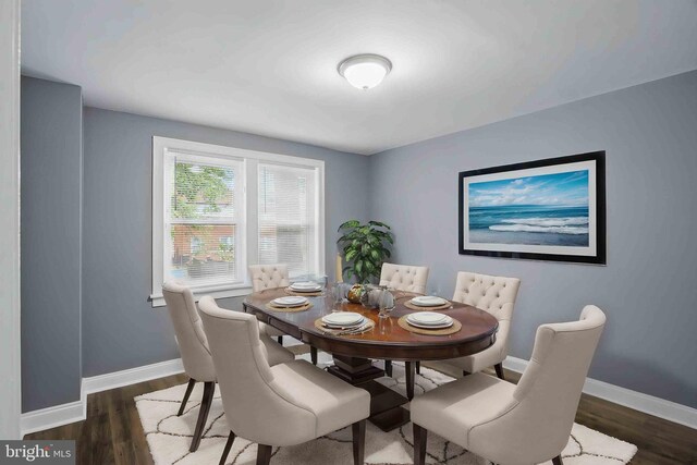 dining area with baseboards and wood finished floors