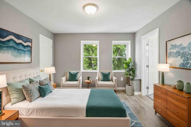bedroom with wood finished floors and baseboards