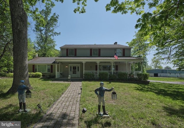 country-style home featuring a porch, a front lawn, and a chimney
