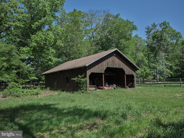 view of pole building featuring fence