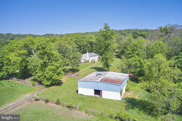view from above of property with a heavily wooded area