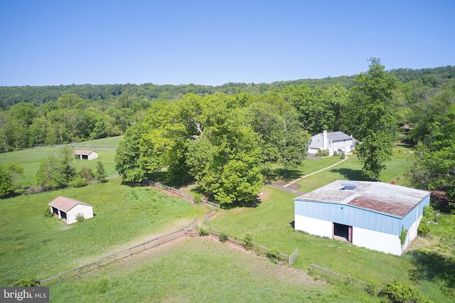 aerial view of property and surrounding area featuring a forest