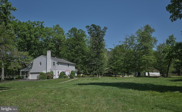 view of grassy yard featuring an attached garage